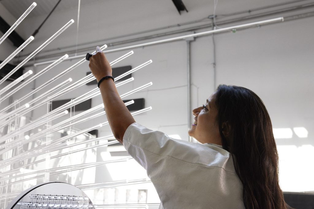 artist working on light sculpture