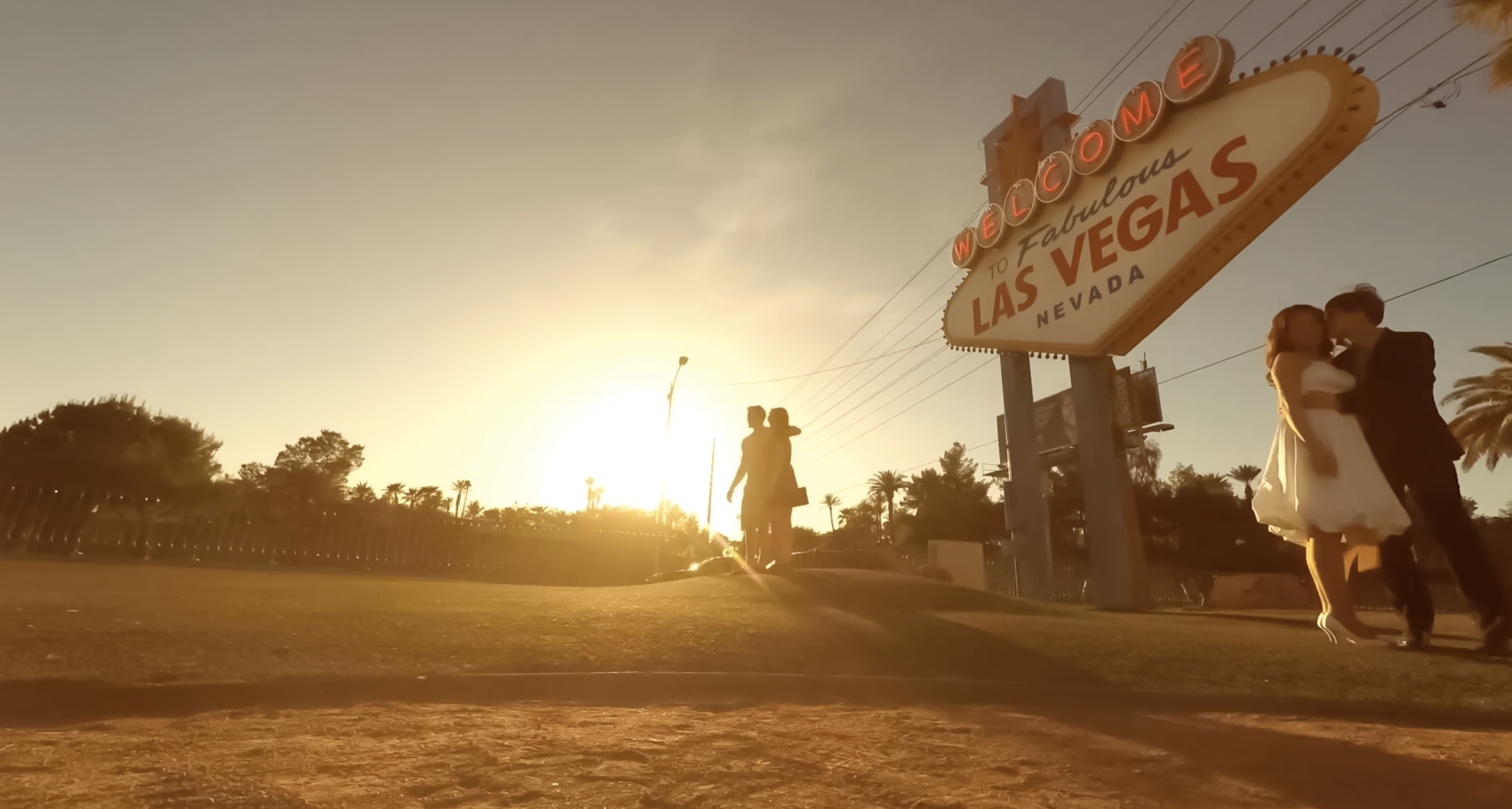 las vegas sign with couple posing in front