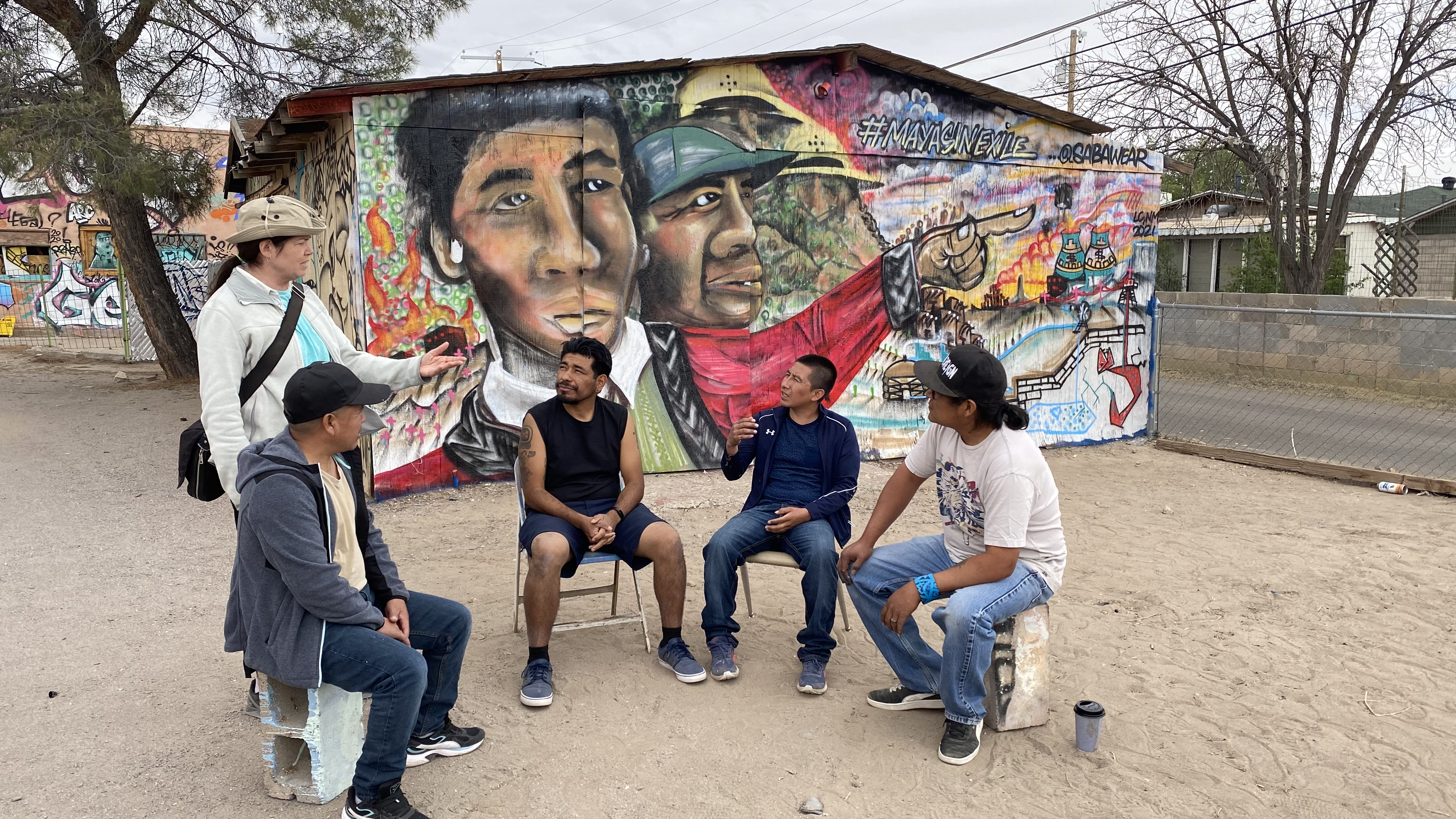 Men sitting in semi circle