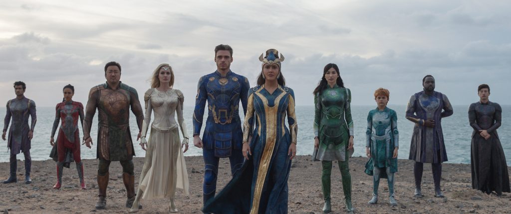 marvel studios eternals characters standing on beach in a row
